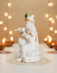 Lord Krishna playing flute in marble sculpture